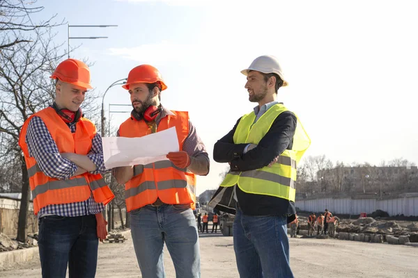 Männliche Bauarbeiter Arbeiter Ingenieure Auf Einer Baustelle Suchen Zeichnungen Helmen — Stockfoto