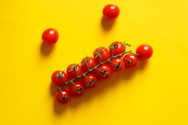 Cherry tomatoes on a yellow background.