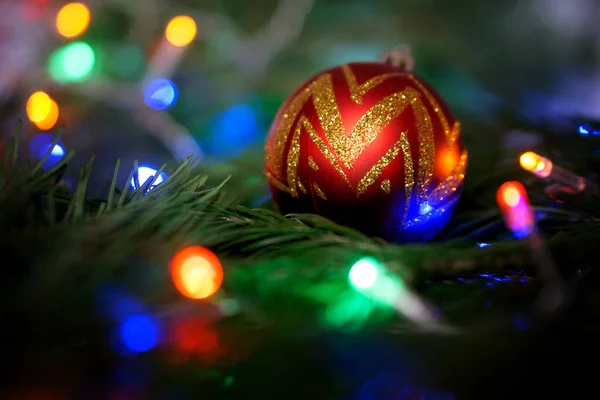 New Year Toy Golden Ball Lies Tree Branch Colorful Lights — Stock Photo, Image