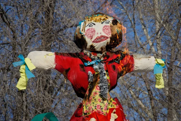 Burning scarecrow doll for the Slavic holiday Maslenitsa. Folk traditions.