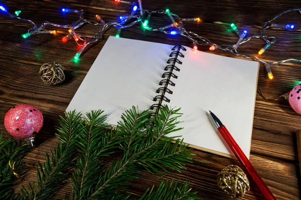 Notebook to record New Year\'s wishes, congratulations and gifts. Template. Opened notebook is located at an angle. Happy New Year and Merry Christmas!
