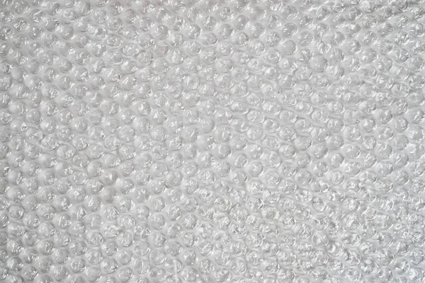 Bubble wrap on a light background. Texture and background. Packing bubble film.