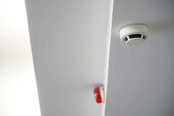 An example of mounting a fire detector and a light indication unit on a multi-level ceiling.