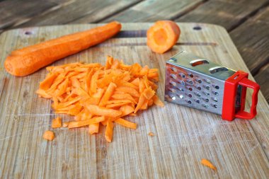 Ahşap bir kesme tahtasında rendelenmiş havuç. Olağandışı gizem ve optik illüzyon.