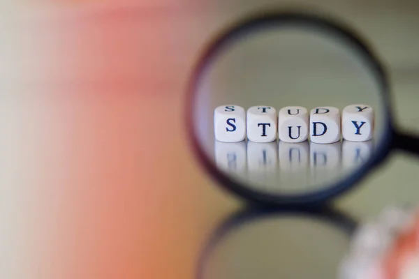 Tekst studie, bekleed met blokjes door een vergrootglas. — Stockfoto