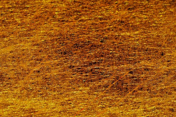 Золотой фон тонкого войлока на темном фоне с хаотом — стоковое фото