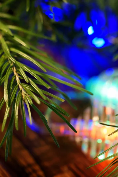 Christmas tree branches and needles along with magical colorful — Stock Photo, Image