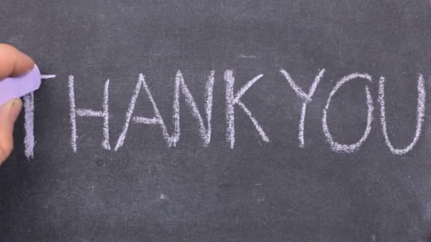 Word thank you written with chalk on blackboard. — Stock Video