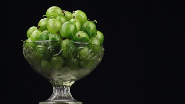 Rotation of a heap of green gooseberries in a glass vase — Stock Video