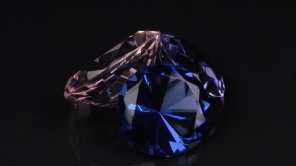 Rotation of three diamonds on a black background with a beautiful reflection. — Stock Video