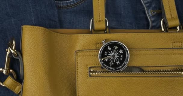 Compass sticks out of the pocket of a female bag. Approaching, crane shot. Travel concept. — Stock Video