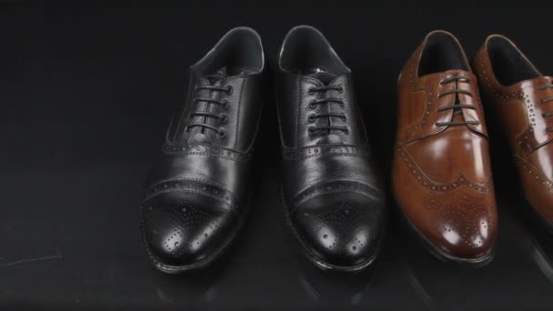 Two pairs of mens classic shoes with laces. Slider shot. — Stock Video