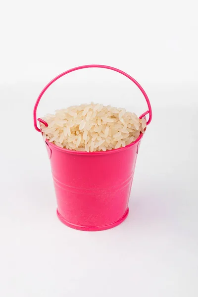 Heap Rice Grains Pink Bucket White Background Copy Space — Stock Photo, Image