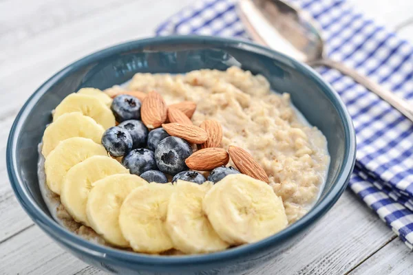 Bowl Oatmeal Porridge Banana Blueberries Almonds Wooden Background — Stock Photo, Image