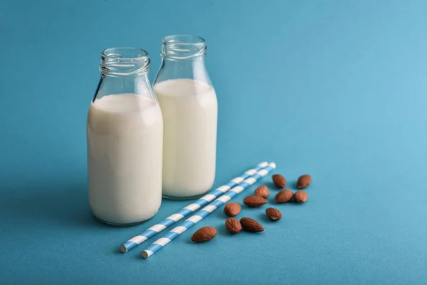 Almond Milk Bottles Almonds Drinking Straws Blue Background — Stock Photo, Image