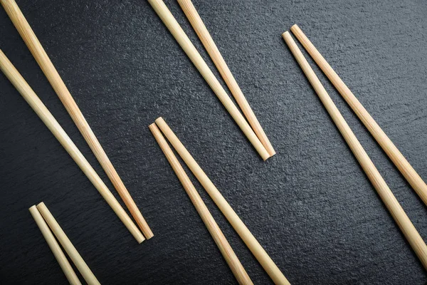 Många Bambu Ätpinnar Svart Skiffer Bakgrund Ovanifrån — Stockfoto