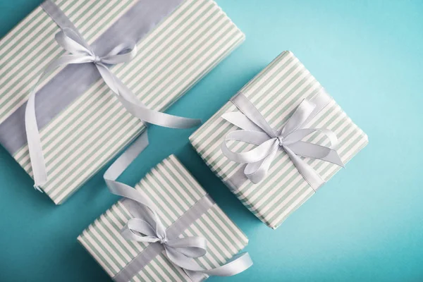 Several Gift Striped Boxes Grey Ribbon Blue Background Top View — Stock Photo, Image