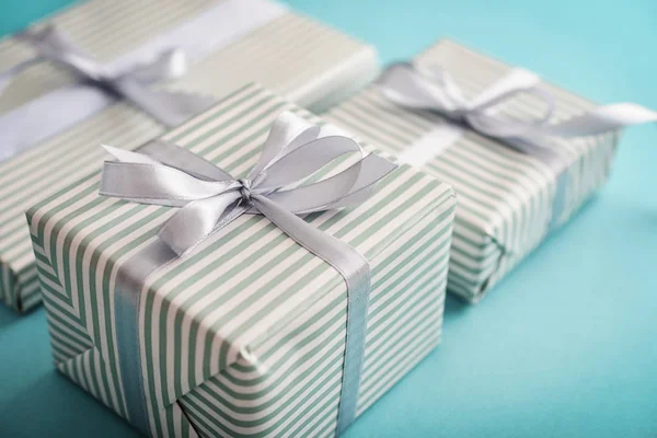 Several Gift Striped Boxes Grey Ribbon Blue Background Closeup — Stock Photo, Image