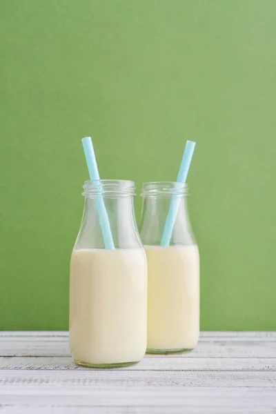 Two Bottles Milk Drinking Straws Green Background — Stock Photo, Image