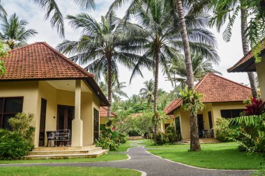 BALI, INDONESIA - JANUARY 14, 2018: Territory Discovery Candidasa Cottages and Villas Hotel at sunny day, Bali, Indonesia clipart