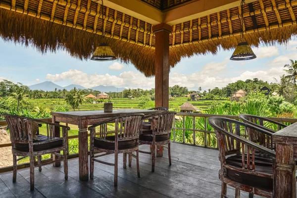 Wooden tables and chairs in empty tropical cafe — 스톡 사진