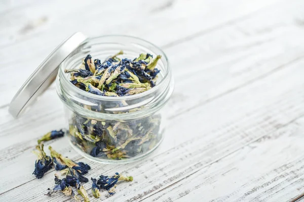 Dried Clitoria flowers in jar — Stock Photo, Image