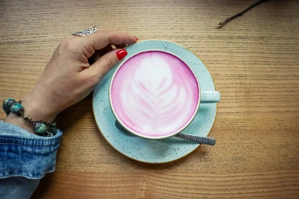 Cup of pink cappuccino in blue cup — Stock Photo, Image