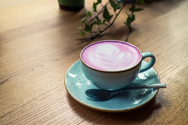 Чашка розового капучино в синей чашке — стоковое фото