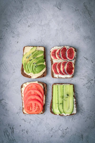 Vegetarian sandwich with cucumber, tomato, figs and avocado