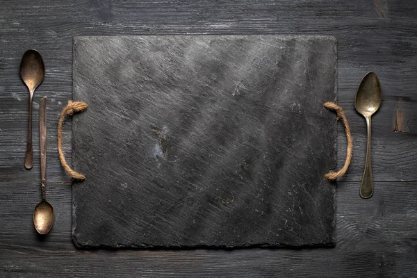 Black Slate Plate Three Vintage Spoons Wooden Board Top View — Stock Photo, Image