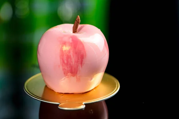 Trendy torta di mousse smaltata a specchio rosa a forma di mela, al buio — Foto Stock