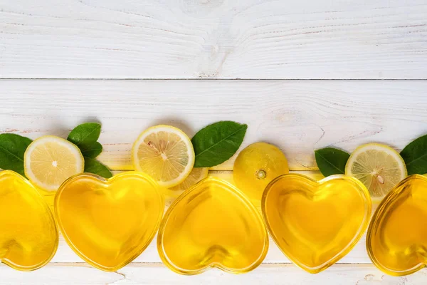 Yellow lemon jelly in heart shaped glass wish slices of lemon an — 스톡 사진