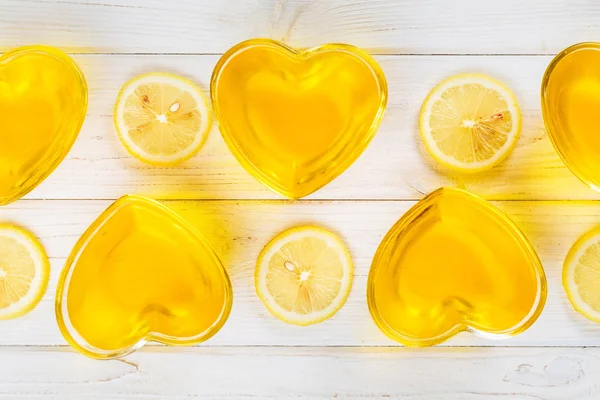 Yellow lemon jelly in heart shaped glass on white wooden backgro — 스톡 사진