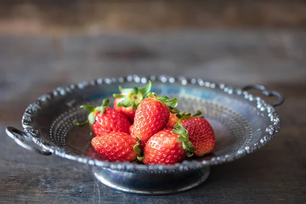 Fresh strawberry in antique metal plate on wooden table — Stock Photo, Image