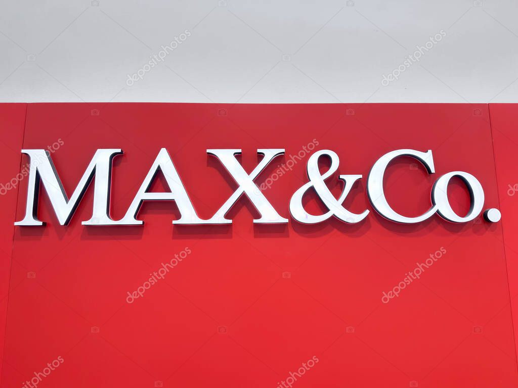 Singapore, Singapore - May 02, 2025 MAX and Co. logo prominently featured on bright red wall background
