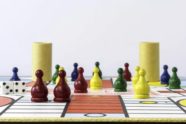 parcheesi  game set up on board with white background