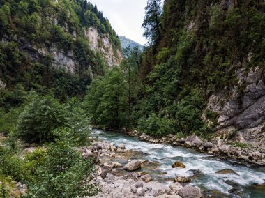 Dağ canyone kayalarda arasında dağ nehir akar