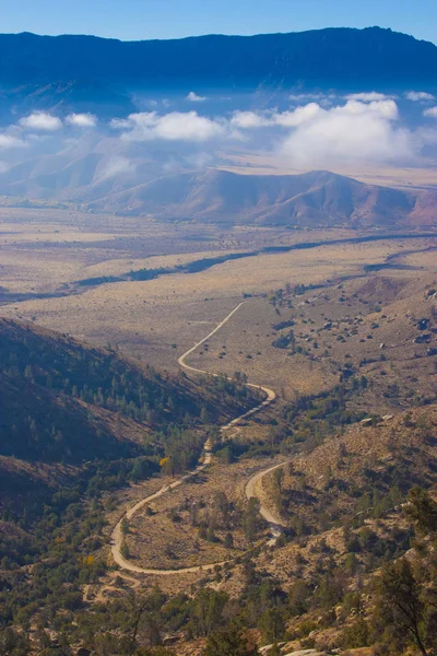 Mountain pass, from which the clouds over the valley can be seen, in the Sierra Nevada, California, USA. The Sierra Nevada is a mountain range in the Western United States.