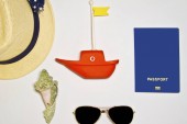 Картина, постер, плакат, фотообои "sea shells, toy boat, hat sunglasses, passport on a light background with sand, top view", артикул 250793888