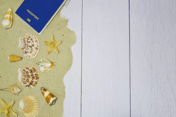 Морські раковини, зірки, паспорт на світлому дерев'яному тлі з піском, вид зверху — стокове фото