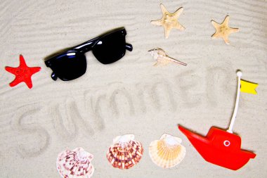 Yaz yazıtlı berrak deniz kumu, metin ve üst görünüm için alan. Deniz kabukları ve güneş gözlüğü ile yaz tatili arka plan