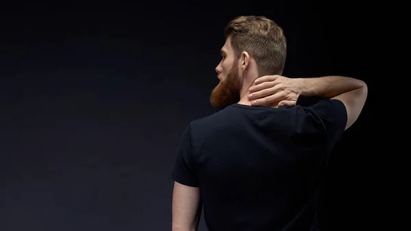 Man turned his back and put hand around neck