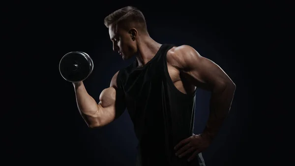 Handsome power athletic man in training pumping up muscles — Stock Photo, Image