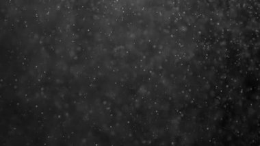 Gece Noel Magic. Küçük beyaz parçacıklar siyah bir zemin üzerine hava akışı. Ağır çekim 240 fps hızında