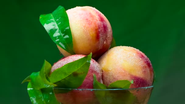 Glass Cup Ripe Juicy Peaches Slowly Rotates Dark Green Background — Stock Video