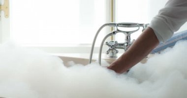 Man's Hand falls into a bath full of foam and enjoys touching it. Filmed at a speed of 120fps