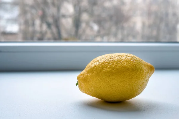 lemon close up. beautiful ripe yellow lemon. lemon on a white background. lemon on the window sill