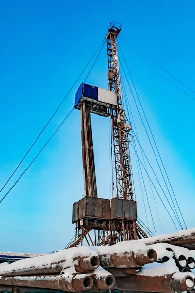 Drilling a deep well with a drilling rig at an oil and gas field. The deposit is located in the Far North beyond the Arctic Circle. The shooting was conducted in the winter during the polar day