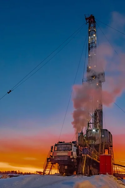 Drilling a deep well with a drilling rig at an oil and gas field. The deposit is located in the Far North beyond the Arctic Circle. The shooting was conducted in the winter during the polar day