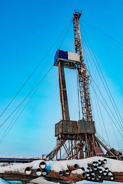 Drilling a deep well with a drilling rig at an oil and gas field. The deposit is located in the Far North beyond the Arctic Circle. The shooting was conducted in the winter during the polar day